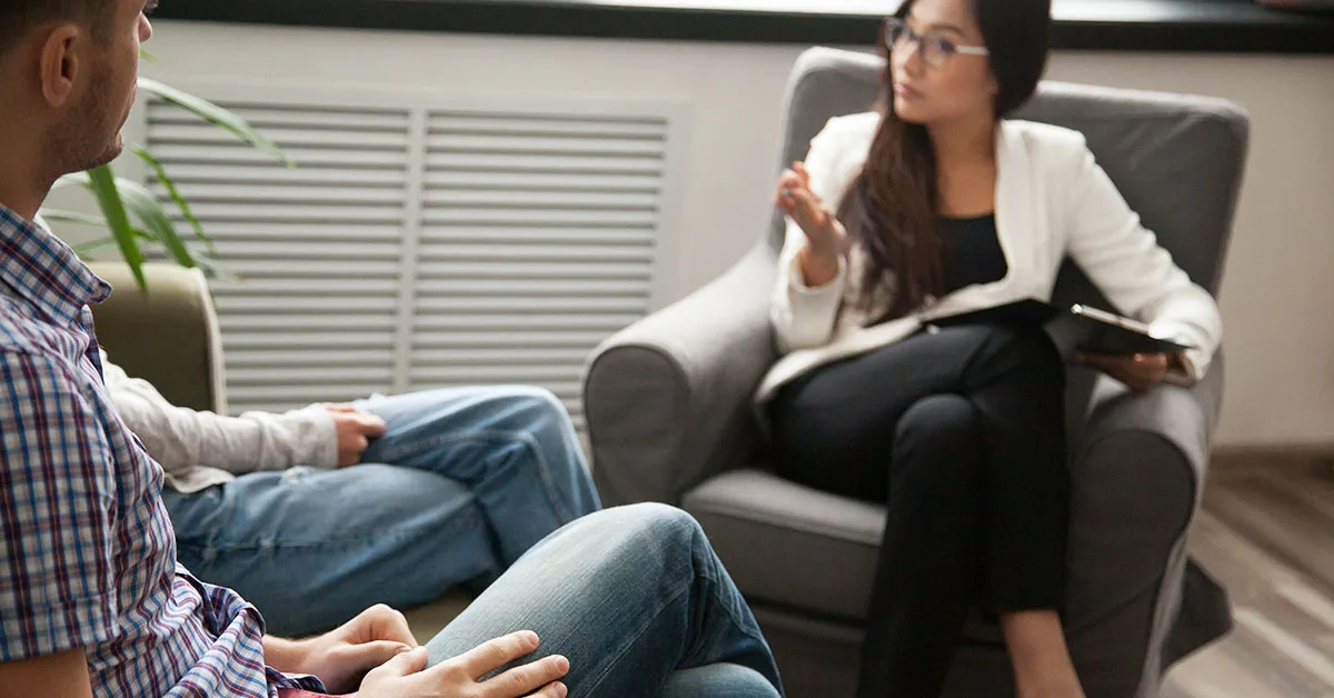 A mental health counselor meeting with a client.